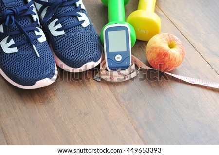 Sport shoe with glucose meter,fruits and dumbbells for using in fitness, concept of diabetes, Exercise in Diabetes Patients concept.