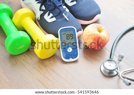 Sport shoe with glucose meter,stethoscope,fruits and dumbbells for using in fitness, concept of diabetes, Exercise in Diabetes Patients concept.