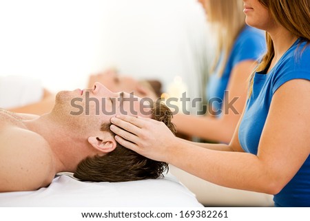 Series of a young couple getting massages by therapists.  Together, as well as separate.  Bright and clean.