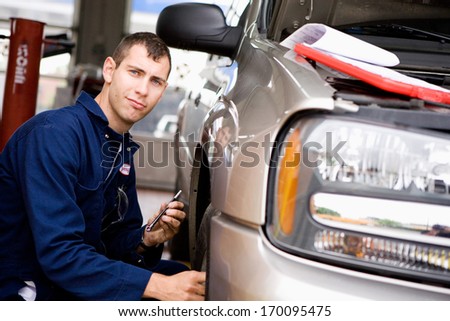 Mechanic: Working on truck tires.