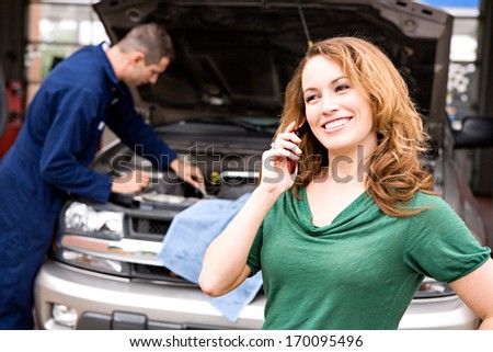 Mechanic: Customer on phone.