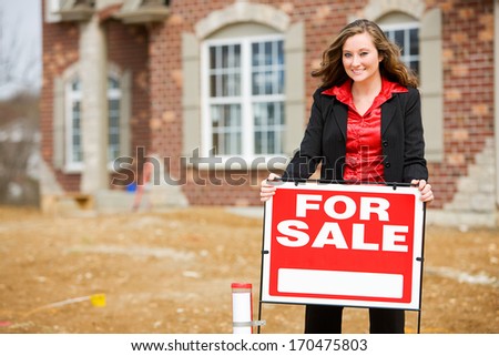 Construction: Real Estate Agent By For Sale Sign.