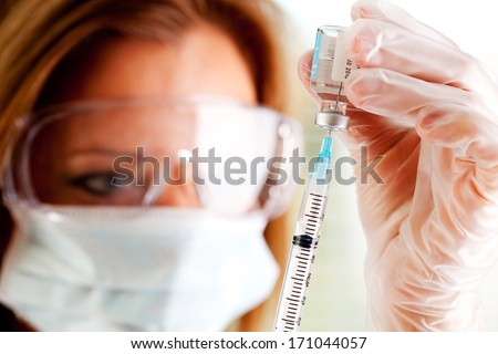 Flu Vaccine: Doctor Drawing Vaccine Into Syringe