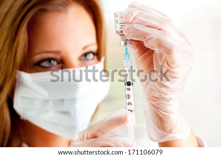 Flu: Doctor Draws Flu Vaccine With Syringe