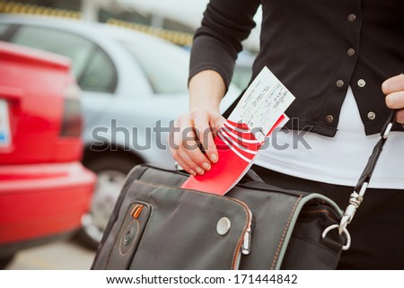 Travel: Woman Putting Travel Ticket Into Bag