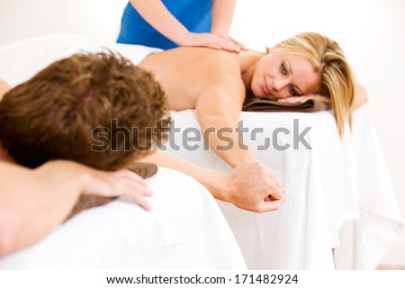 Massage: Couple Holds Hands During Romantic Massage