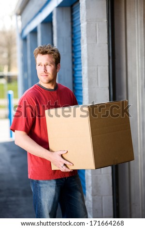 Storage: Man Carrying Packing Box To Storage Unit
