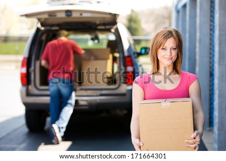 Storage: Woman Carrying Box To Storage Unit