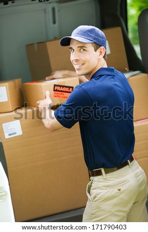Delivery: Cheerful Employee Getting Package From Truck