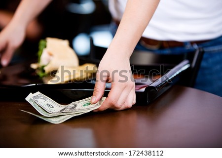 Coffee Shop: Server Picking Up a Cash Tip