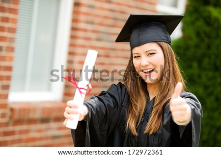 Graduate: Woman Gives Thumbs Up After Graduation
