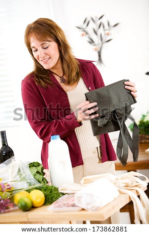 Reusable Bags: Woman Folding Fabric Shopping Bags