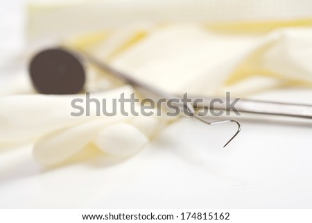 Dental: Dental Pick with Gloves and Mirror Behind