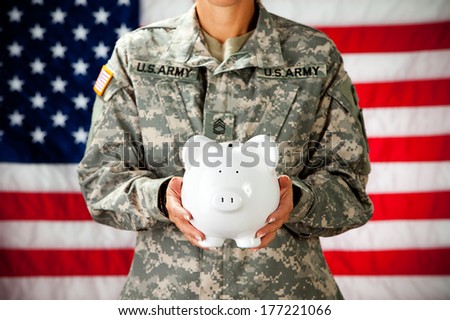 Soldier: Female Holding Up Piggy Bank