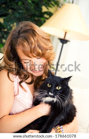 Pets: Woman Sits On Couch With Cat