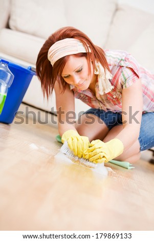 Cleaning: Woman Scrubs Floor During Spring Cleaning