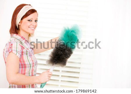 Cleaning: Cheerful Woman Dusts Window Blinds