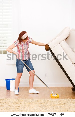 Cleaning: Strong Woman Lifts Couch To Clean