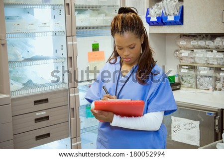 Hospital: Female Nurse In Medical Supply Area