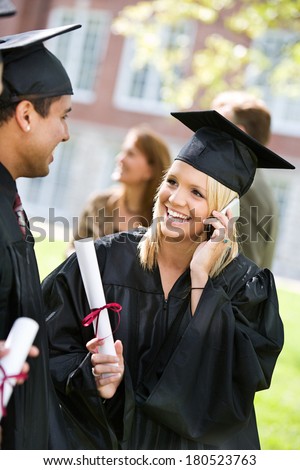 Graduation: Girl Talks On Cell Phone To Friend