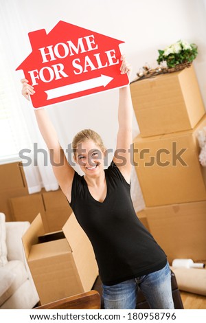 Moving: Woman Holds For Sale Sign In The Air