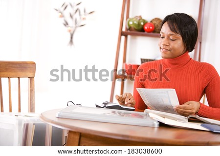 Taxes: Happy Woman Working On Taxes
