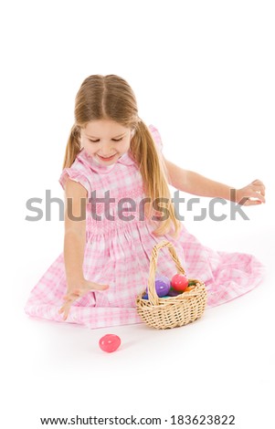 Easter: Girl Picks Up Plastic Easter Eggs