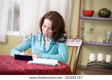Finances: Pretty Woman Writing Checks and Paying Bills