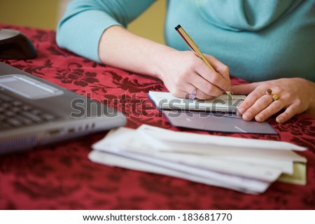 Finances: Anonymous Woman Writing Checks