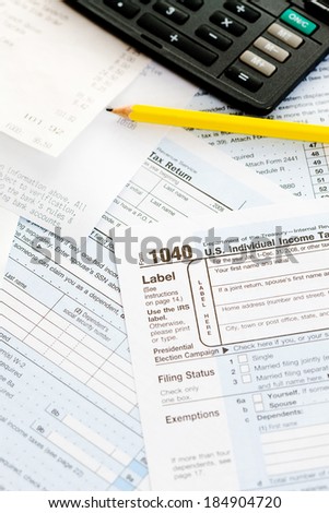 Taxes: Ready To Fill Out 1040 Form with Pencil and Calculator