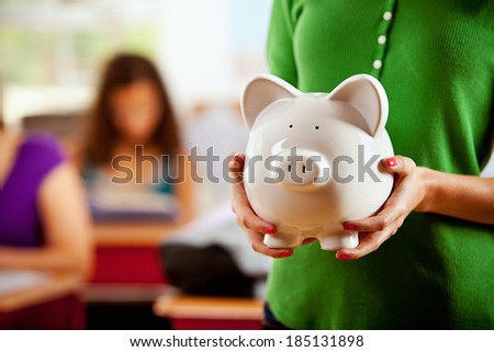 Students: Female Student Holding Piggy Bank
