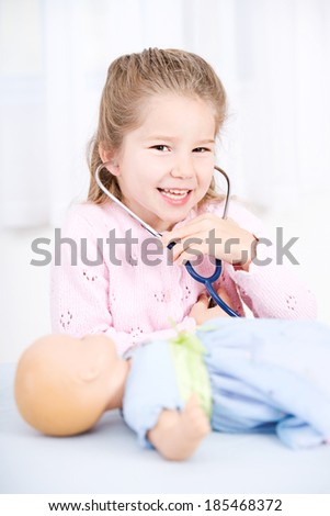 Nurse: Young Girl Listens To Baby Doll With Stethoscope