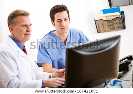 Doctor: Doctors Look At Exam Results On Computer