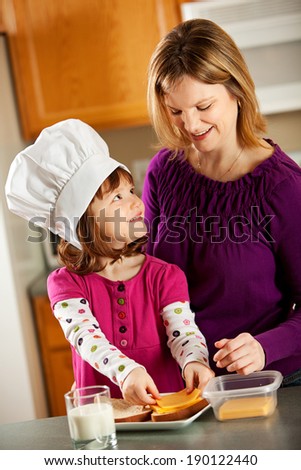 Snacktime: Mother Helps Little Chef Make Grilled Cheese
