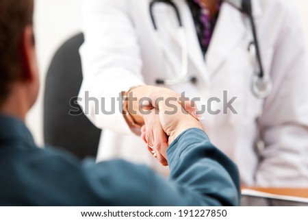 Doctor: Anonymous Patient And Female Doctor Shaking Hands