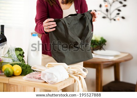 Woman Folding a Reusable Fabric Bag