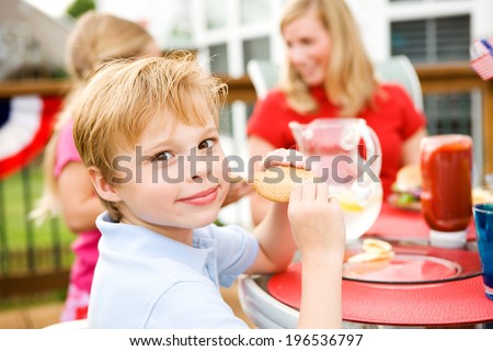 Summer: Cheerful Boy Having Cookie After Dinner