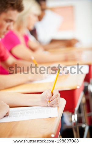 Classroom: Focus On Hands Of Students Taking Tests