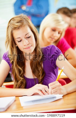 Classroom: Pretty Student Takes Test At Desk