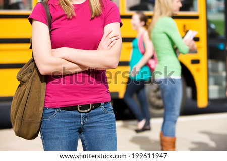 School Bus: Anonymous Student With Bus In Background