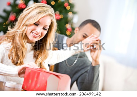 Christmas: Woman Trying To Hide Gift Contents From Husband