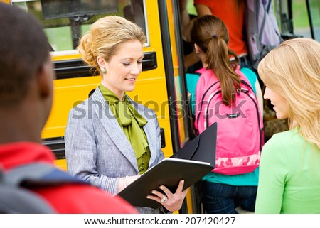Bus: Teacher Checking Off Students At Field Trip