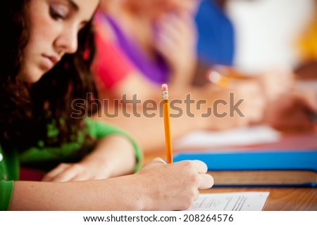 Students: High School Teen Taking Quiz At Desk