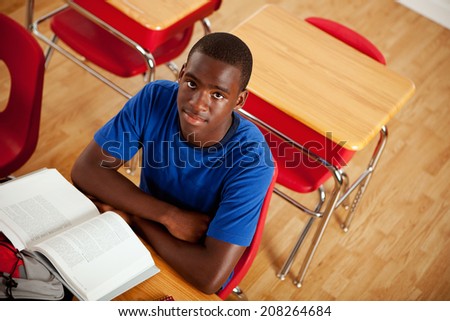 Students: Serious African American Teen Male At Desk In Class