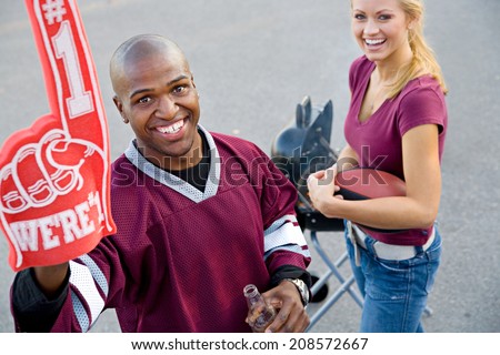 Tailgating: College Guy Holds Up Number One Foam Finger