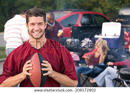 Tailgating: Smiling Fan Holding Ball After Team Win
