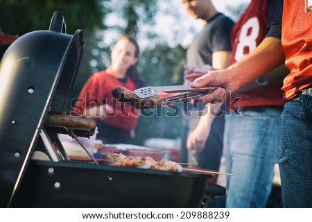 Tailgate: Man Works The Grill At Tailgating Party