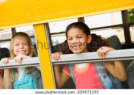 Education: Two Friends Look Out Of School Bus Windows