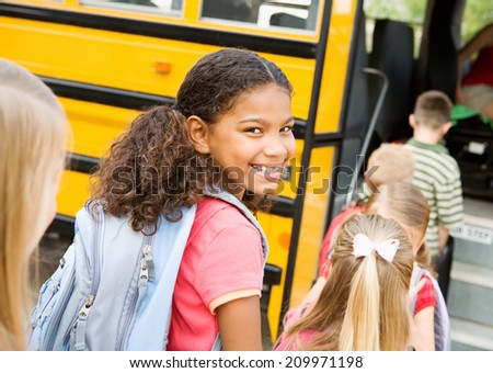 Education: Smiling Elementary Student Ready To Board Bus