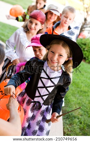 Halloween: Line Of Kids Ready For Trick Or Treat Candy On Halloween